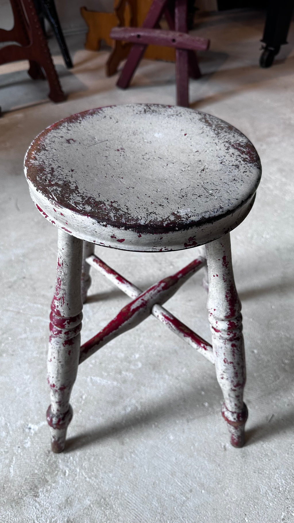 Gray and Red Milking Stool