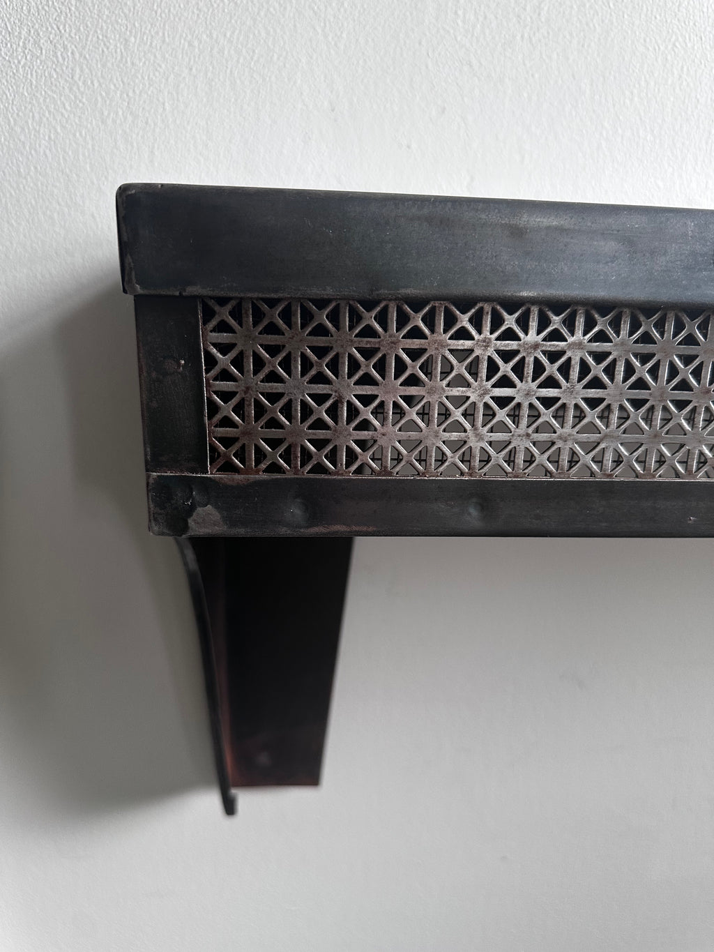 Stamped steel radiator shelf