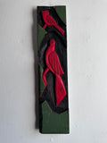 Carved wooden bird panel in red green and black