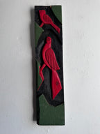 Carved wooden bird panel in red green and black