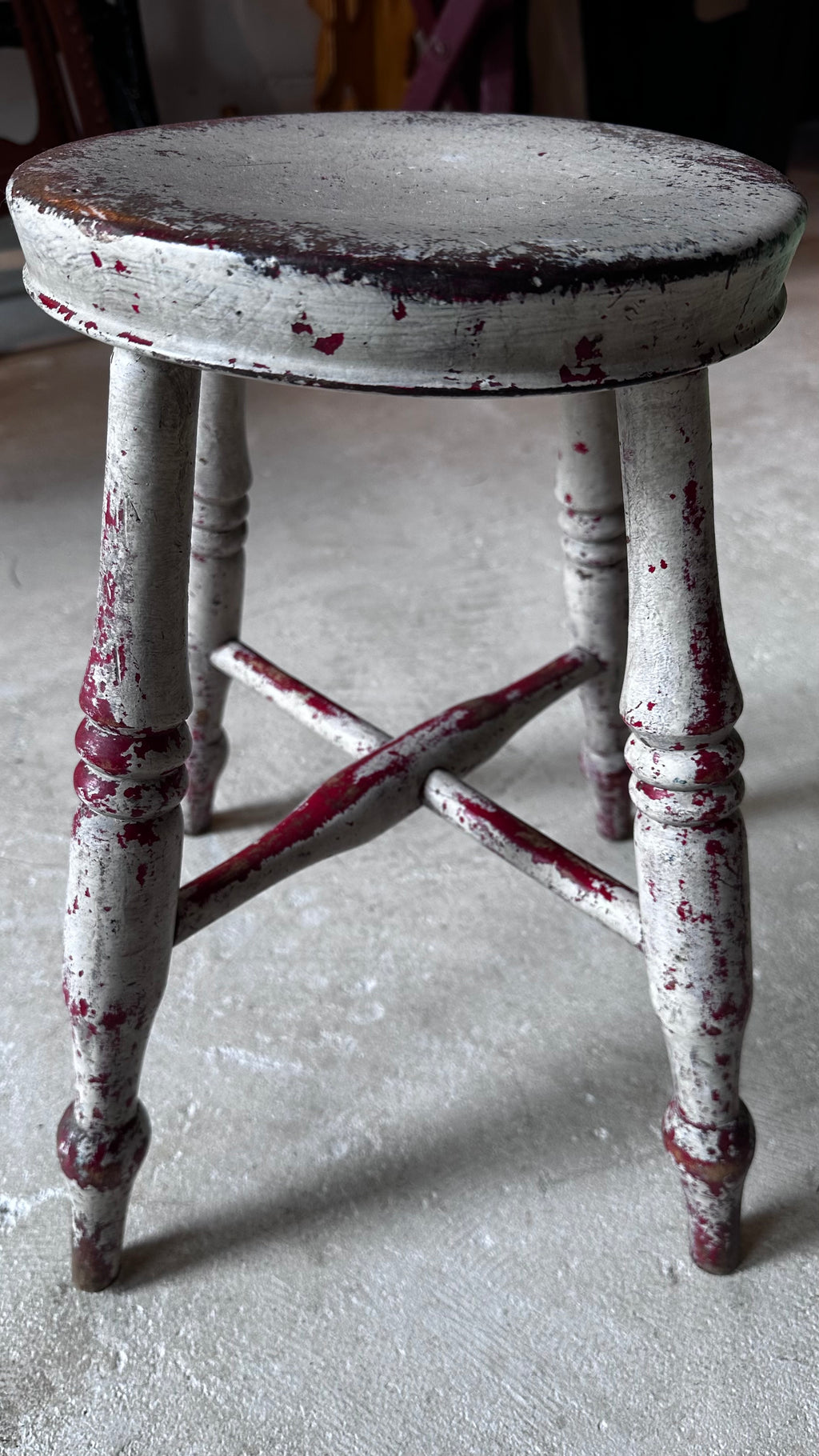 Gray and Red Milking Stool