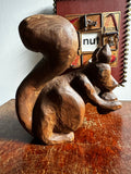 Carved wooden squirrel with acorn