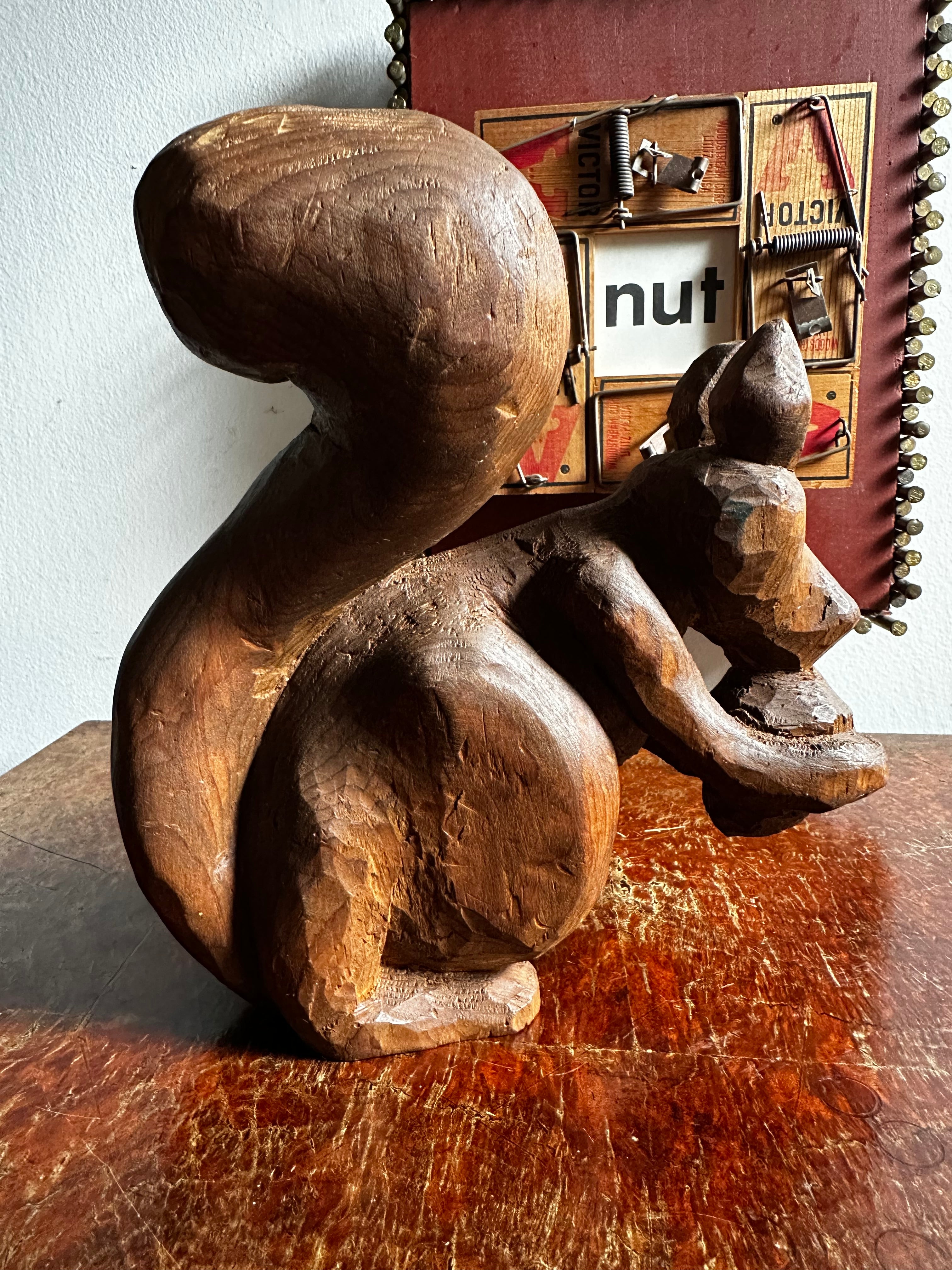 Carved wooden squirrel with acorn