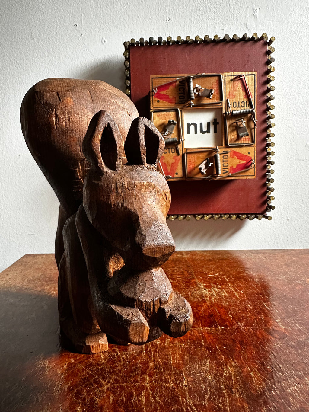 Carved wooden squirrel with acorn