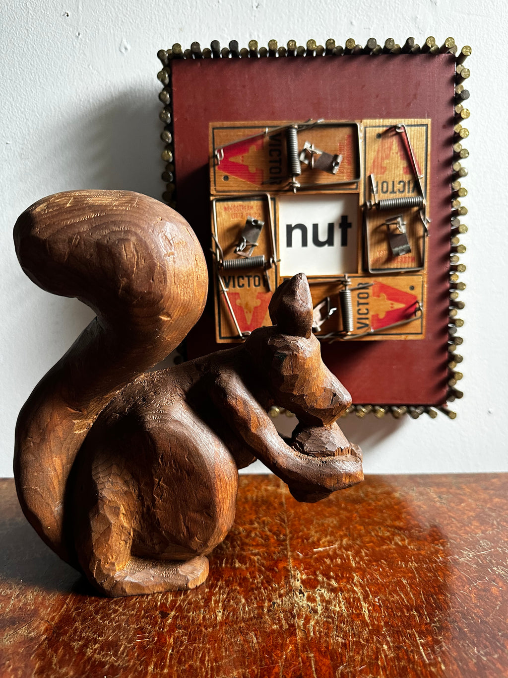Carved wooden squirrel with acorn