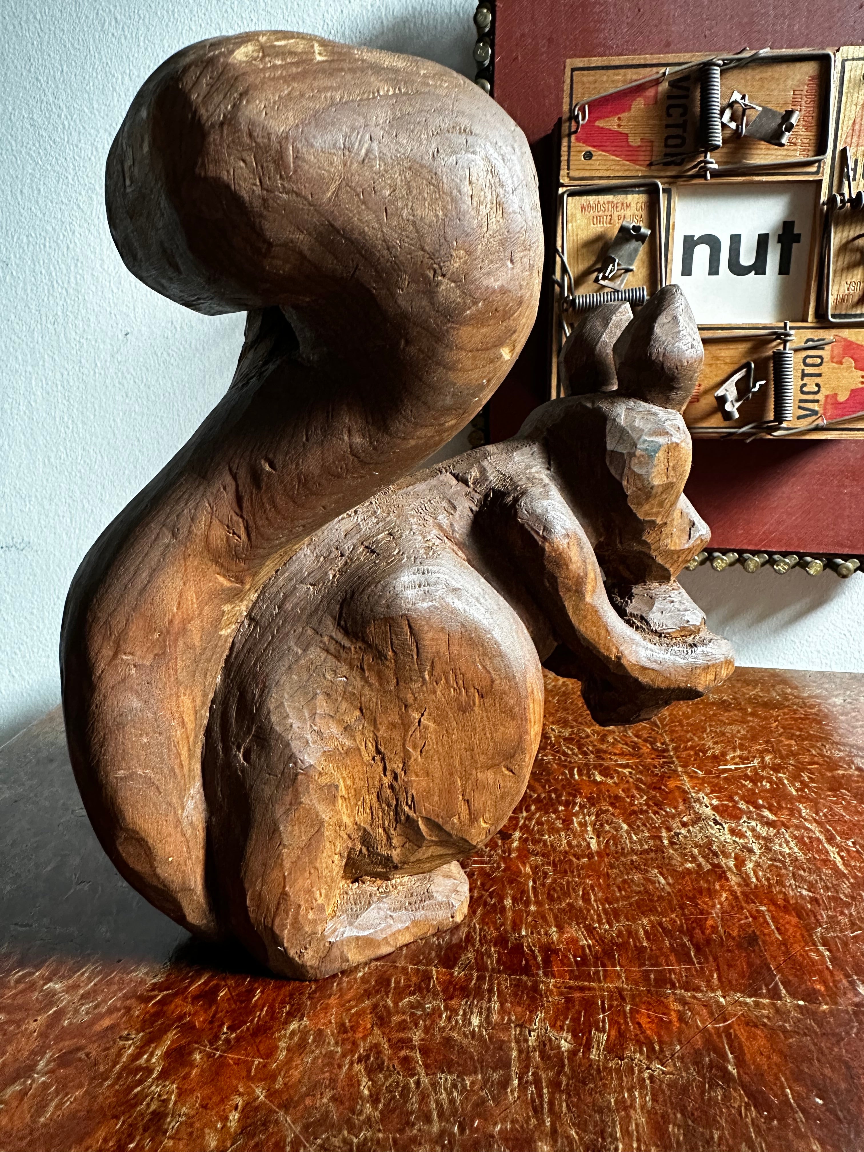 Carved wooden squirrel with acorn